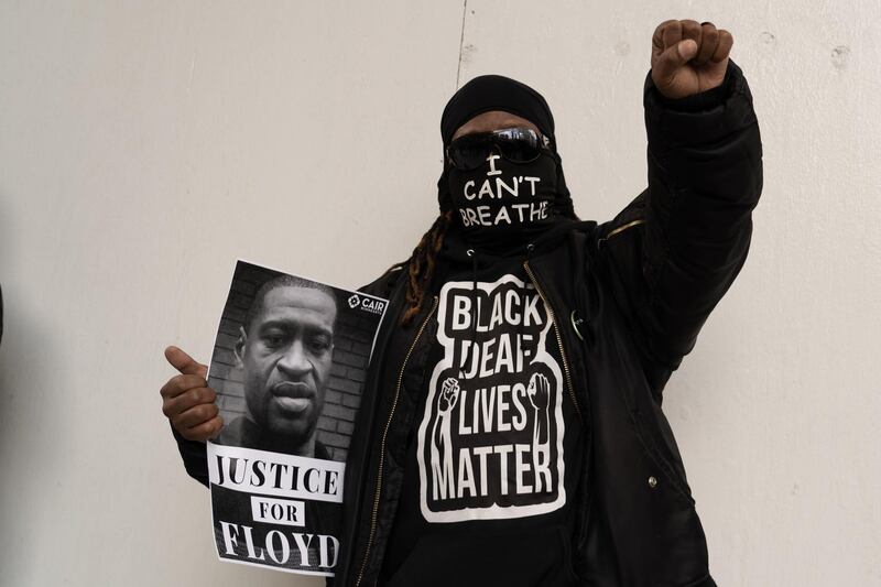 A man holds a portrait of George Floyd outside the Hennepin County Government Centre. Willy Lowry / The National