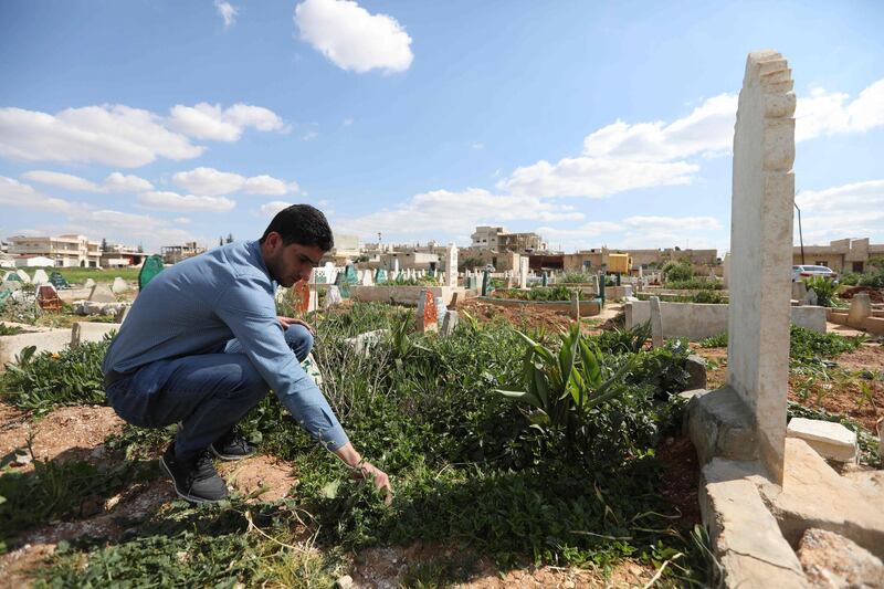 Abdulhamid Yusuf, who lost 19 members of his family, including his wife and two children, visits the graves of his relatives in Khan Shaykhun, on March 31, 2018.
On his wedding anniversary this year, 29-year-old Syrian widower Abdulhamid Yusuf will have nothing to remember but a chemical attack that killed his wife and two small children.  / AFP PHOTO / OMAR HAJ KADOUR