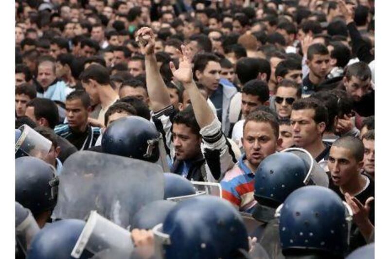 Students face policemen during a march in central Algiers in defiance of a government ban on demonstrations in the Algerian capital.