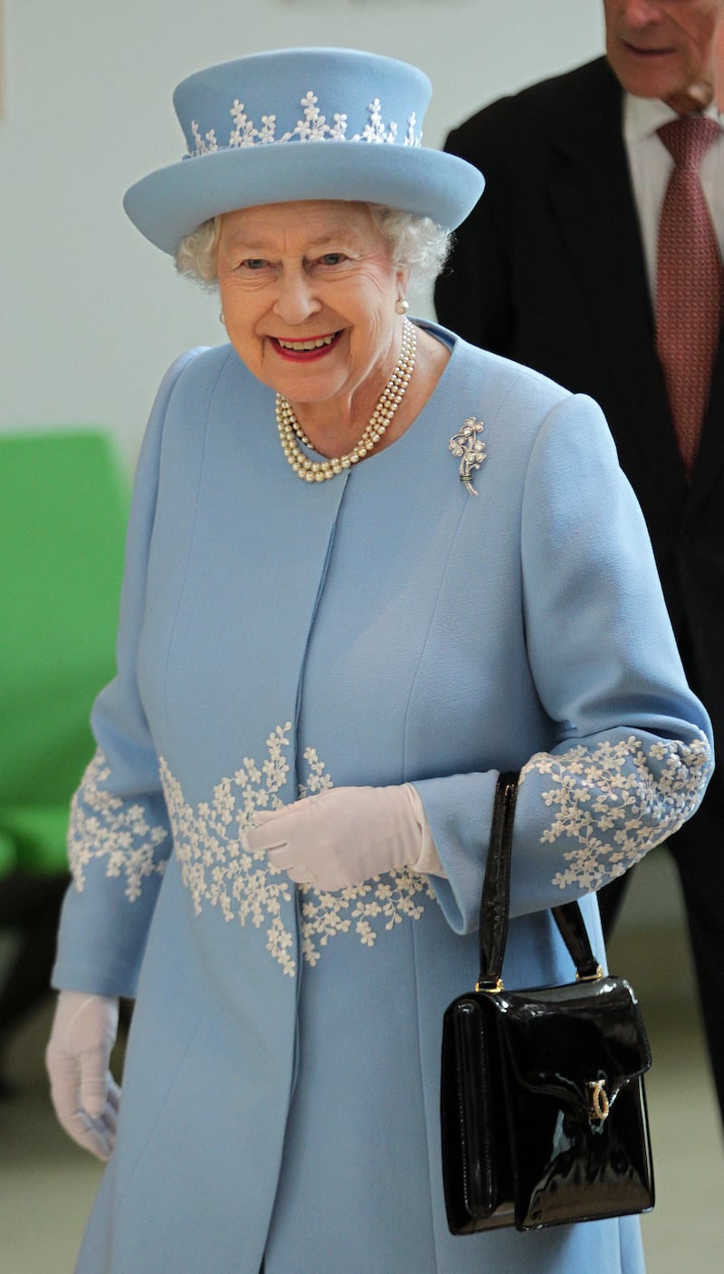 Queen Elizabeth II wears the diamond shamrock brooch, gifted to her by the late Sultan Qaboos bin Said of Oman to celebrate her diamond jubilee, during a visit to Northern Ireland in June 2012. AFP