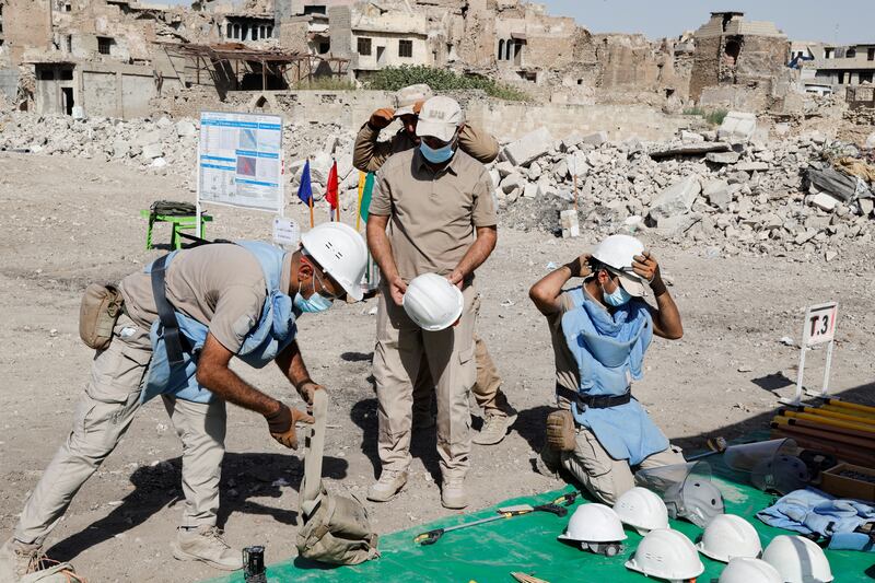 Members of a demining squad take part in an operation to clear mines in the Old City of Mosul.