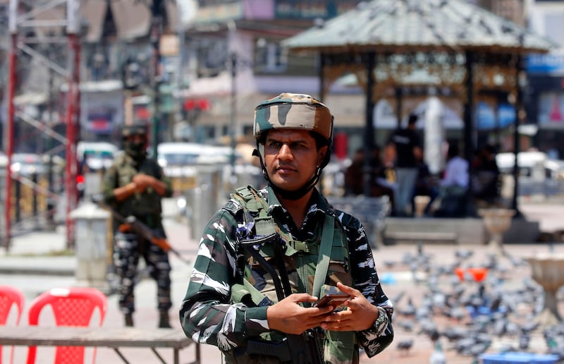 Indian paramilitary soldiers stand guard in Srinagar, Indian Kashmir.  Two non-Muslims were killed in two separate incidents by suspected militants in Indian Kashmir.  A bank manager from Rajasthan was shot in Areh Mohanpora area of south Kashmir's Kulgam district, and a migrant labourer was killed and another injured in Chanoora area of Budgam districts on 02 June 2022.  Four non-Muslims were killed since 12 May 2022.  Traumatized by one after another targeted killings at the hands of suspected militants, hundreds of migrant Hindu employees in India-administered Kashmir have fled in the last few days to Jammu and other parts of India and these migrant Hindus, locally called Pandits, are among 76319 families which migrated to "a safer place" in 1989-90. EPA