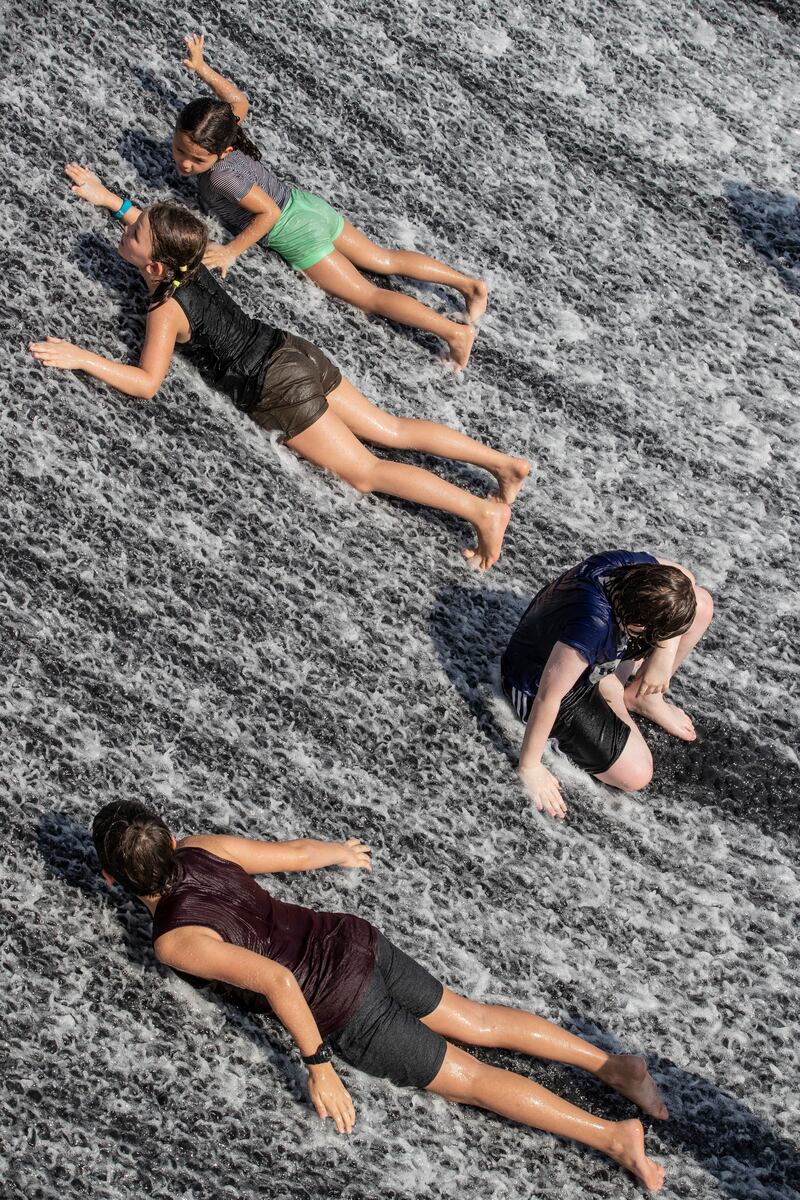 Cooling down at the Expo 2020 Water feature. (Photo: Antonie Robertson / The National)