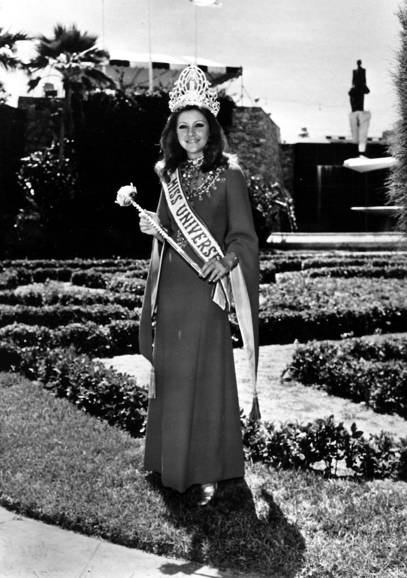 Georgia Risk, Miss Universe 1971, poses with the official Miss Universe crown, sash and sceptor. Miss Universe no longer receives the sceptor, but she still receives a crown, sash and prize package that includes scholarships, jewelry, watches, clothing, and more. Courtesy Miss Universe