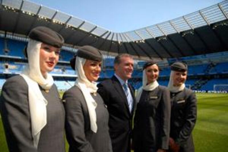 Etihad Airways air hostesses with Garry Cook, MCFC Chief Exec.at the Manchester City Football Ground where a three-year sponsorship deal with Etihad Airways was signed today, 24th May, 2009. Photo by John Robertson, © www.jr-photos.com, 2009.