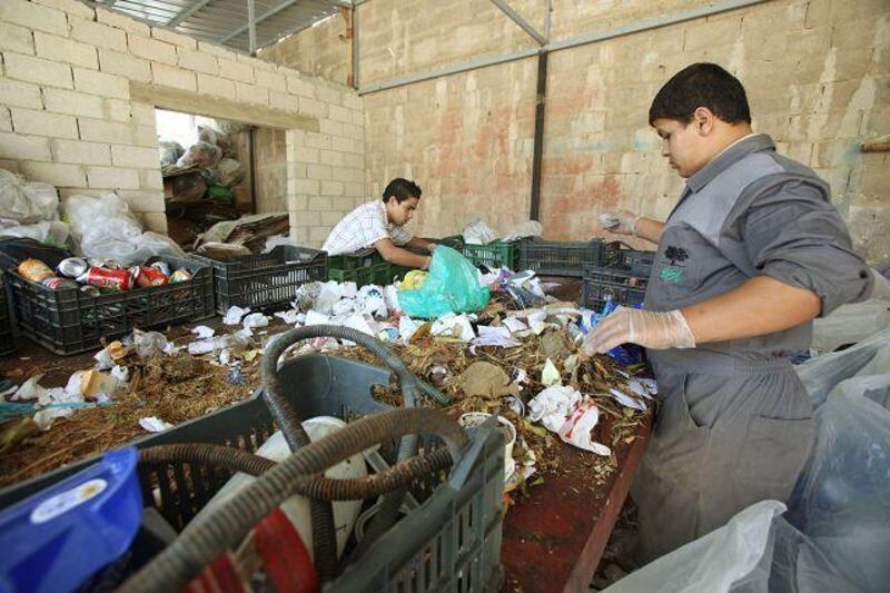 Two scavengers collect garbage at the Entity Green Training for recycling in Ein al-Basha near Amman, Jordan, October 10, 2009.