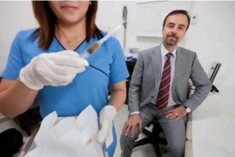 Dr Parviz Rashvand, right, of Dubai’s Synergy Medical Clinic. Jaime Puebla / The National
