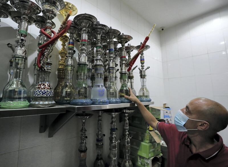 Ras Al Khaimah, United Arab Emirates - Reporter: Tito Al Ghanaima prepares shisha at Orkied Cafe. Shisha cafes are now opening in RAK. Thursday, August 6th, 2020. Ras Al Khaimah. Chris Whiteoak / The National