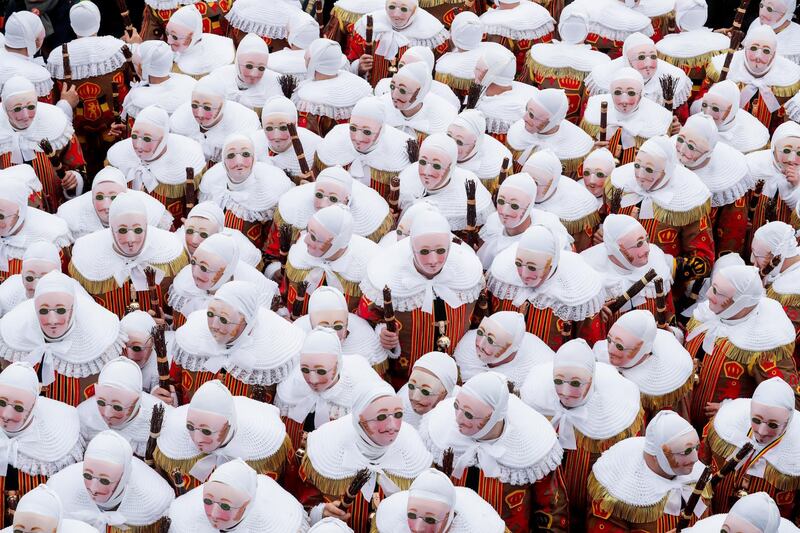 Festival participants known as 'Gilles', wearing traditional costumes, during Carnival celebrations in the streets of Binche, Belgium. EPA
