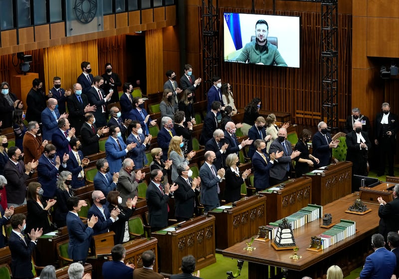 Ukrainian President Volodymyr Zelenskyy receives a standing ovation as he appears via videoconference to make an address to Canada's Parliament. AP