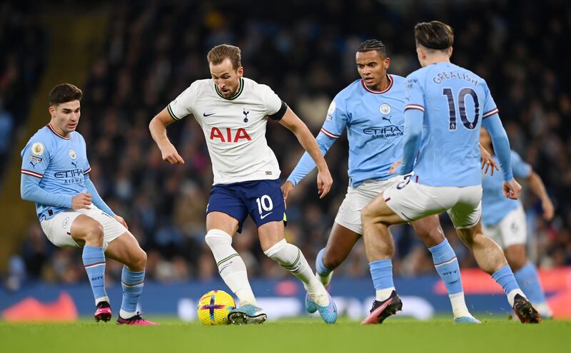 Harry Kane of Tottenham Hotspur is challenged by Julian Alvarez and Manuel Akanji of Manchester City during their Premier League match at the Etihad Stadium on January 19, 2023. Getty