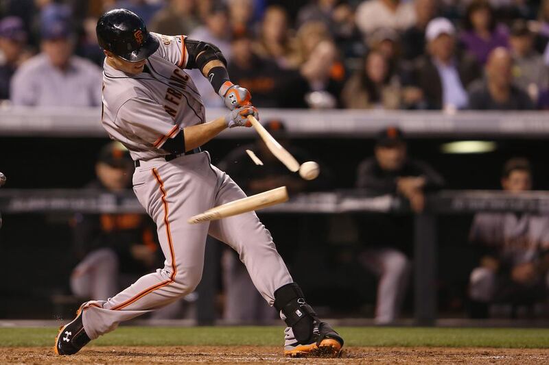 Buster Posey #28 of the San Francisco Giants breaks his bat as he hits into a double play and collects an RBI against the Colorado Rockies in the third inning at Coors Field in Denver, Colorado.   Doug Pensinger / Getty 