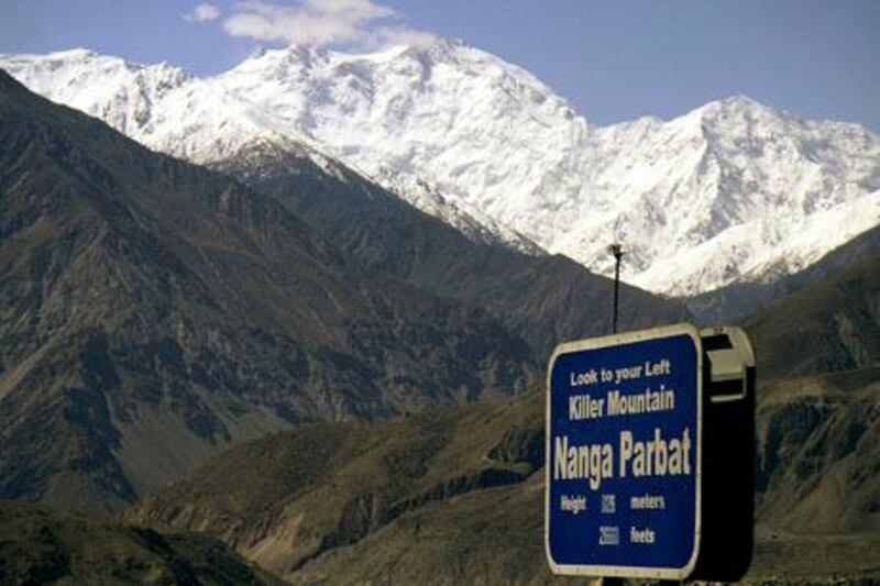 CORRECTS THE NUMBER OF THE KILLED FOREIGN TOURISTS - FILE - In this May 4, 2004 file photo, Nanga Parbat, the ninth highest mountain in the world, is seen from Karakorum Highway leading to neighboring China in Pakistan's northern area. Gunmen wearing police uniforms killed nine foreign tourists and one Pakistani before dawn Sunday, June 23, 2013 as they were visiting one of the worldÕs highest mountains in a remote area of northern Pakistan, officials said. (AP Photo/Musaf Zaman Kazmi, File)