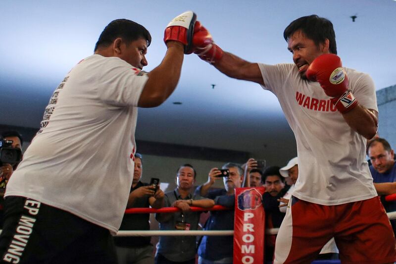 epa06879847 Filipino senator and boxing icon Manny Pacquiao (C) runs through some exercises at a gym in Kuala Lumpur, Malaysia, 11 July 2018. Manny Pacquiao and Lucas Matthysse have arrived in Malaysia ahead of the WBA welterweight championship fight, dubbed 'Fight of the Champions', which will take place in Kuala Lumpur on 15 July 2018.  EPA/FAZRY ISMAIL