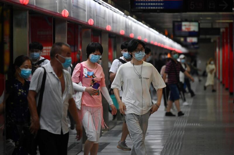 Passengers exit a train at a subway station in Beijing, China. AFP