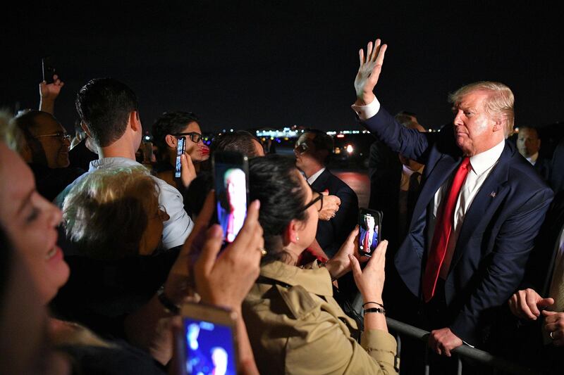 US President Donald Trump meets fans after stepping off Air Force One upon arrival at Miami International Airport in Miami, Florida.  AFP