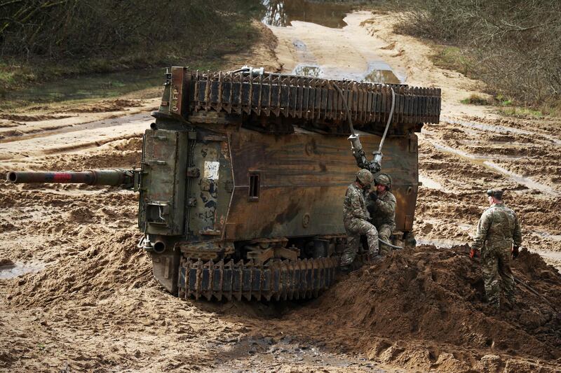 British soldiers recover an overturned armoured vehicle at an exercise in Bordon, Hampshire. Analysts say UK armed forces are in a critical state. AFP