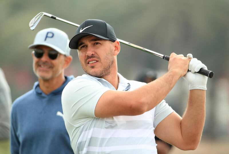 ABU DHABI, UNITED ARAB EMIRATES - JANUARY 15: Brooks Koepka of The United States in action as his swing coach Claude Harmon III looks on during the Pro-Am ahead of the Abu Dhabi HSBC Championship at Abu Dhabi Golf Club on January 15, 2020 in Abu Dhabi, United Arab Emirates. (Photo by Andrew Redington/Getty Images)