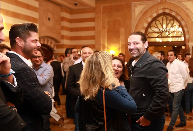 Lebanese Prime Minister Saad Hariri (R) greets supporters in his house in downtown Beirut while waiting for the electoral results. Anwar Amro / AFP