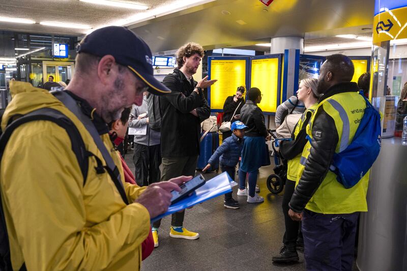 Travellers wait at the Central Station in  Amsterdam as train traffic throughout the north of the Netherlands was halted due to a storm. EPA