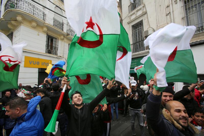 FILE PHOTO: People wave Algerian national flags during a protest calling on President Abdelaziz Bouteflika to quit, in Algiers, Algeria March 22, 2019. REUTERS/Ramzi Boudina/File Photo