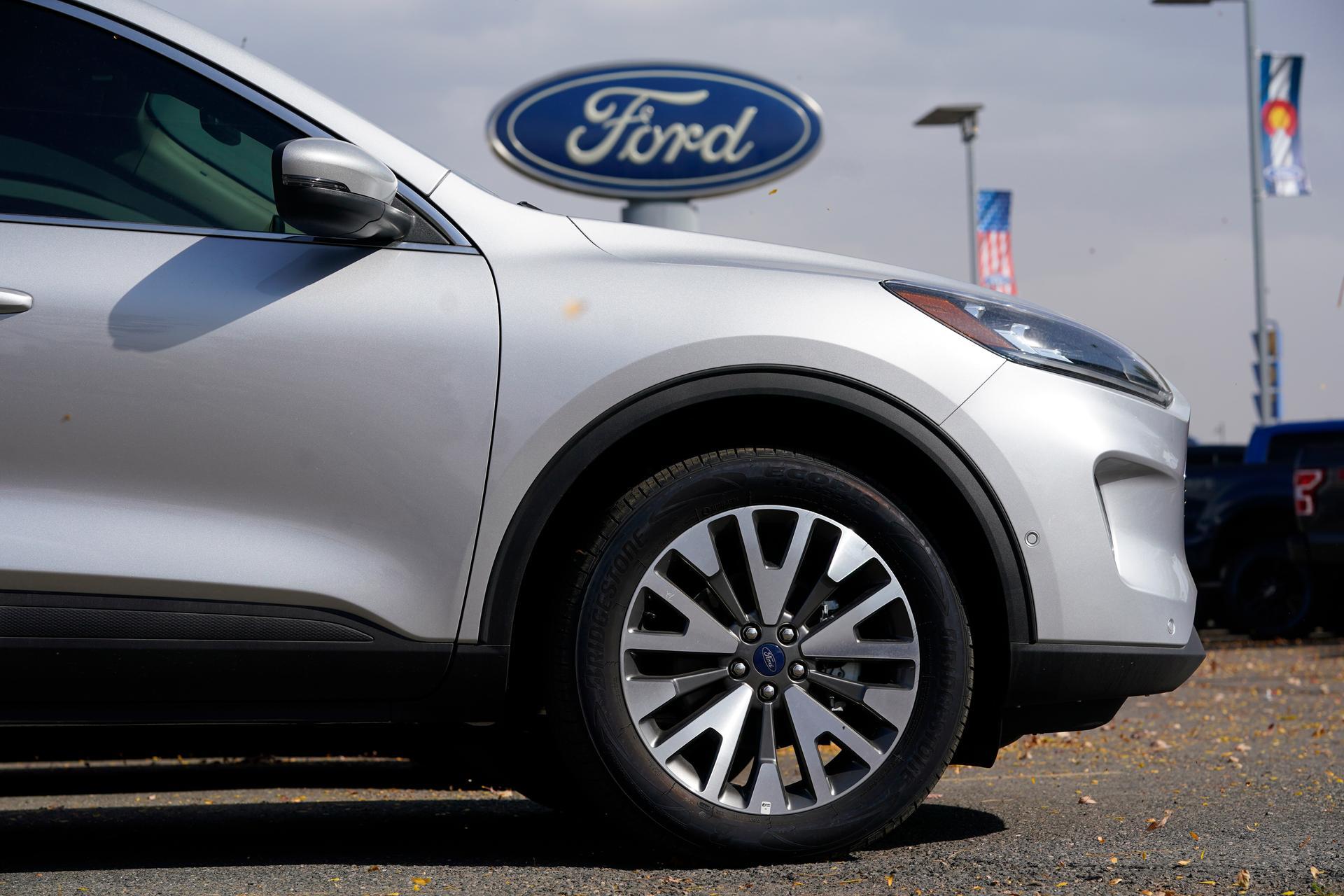 A Ford Escape sports utility vehicle at a dealership in Denver. The car maker is bringing forward a planned maintenance shutdown of the Kentucky plant that makes the vehicle as it faces a shortage of semiconductors. AP Photo