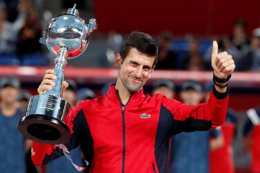 Novak Djokovic celebrates with the Japan Open trophy after his win over John Millman in the final. Reuters