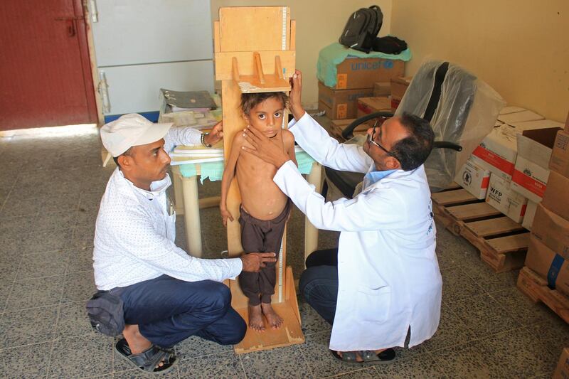 Medical staff measure the height of the malnourished boy Hassan Merzam Muhammad, at a medical center in Abs district of Hajjah province, Yemen. REUTERS