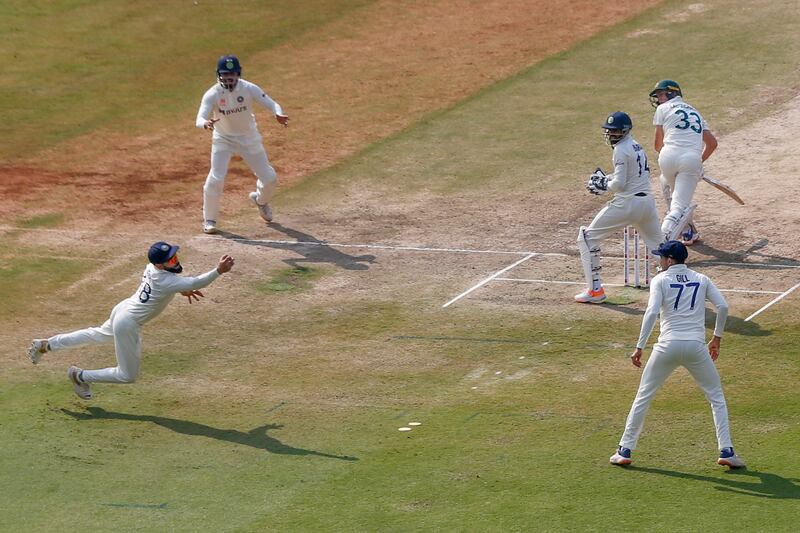 India's Virat Kohli dives to stop a ball during the third cricket test match between India and Australia, in Indore, in India. AP