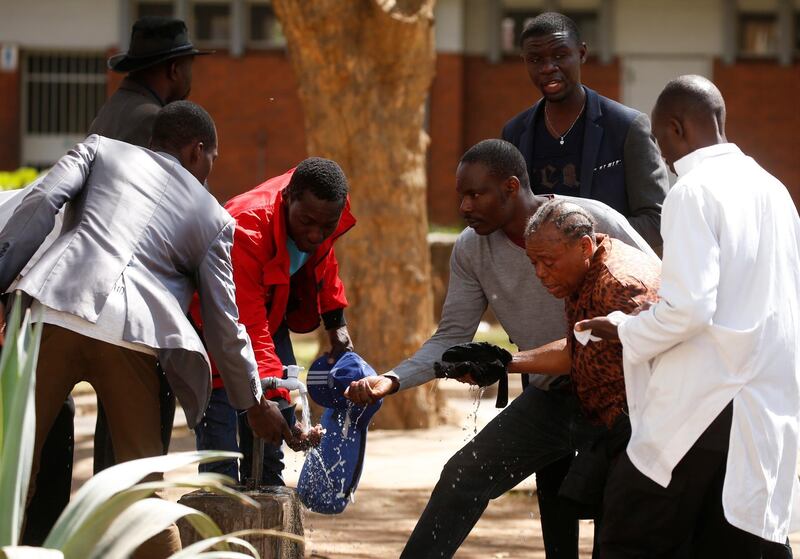 Bystanders assist a woman injured. Reuters