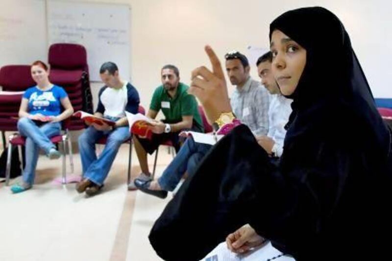 Communication Officer with the National Rehabilitation Centre Shaima Al Jabry, right, trains physical education teachers how to teach children about the dangers of drugs, smoking and alcohol. Christopher Pike / The National