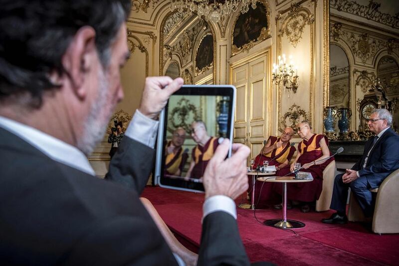 The Dalai Lama (centre) sits next to French Buddhist monk Matthieu Ricard (left) and French senator Michel Raison (right) as he addresses a meeting with members of the parliamentary international group on Tibetan issues at the Salons de Boffrand at the French Senate premises in Paris. The Dalai Lama is on a six-day visit to France for the first time in five years. AFP