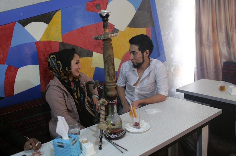 Afghan singer Matin speaks to his girlfriend in a cafe.