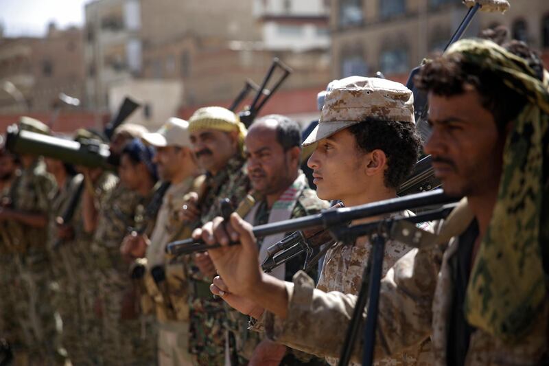 FILE - In this Feb. 20, 2020 file photo, Houthi rebel fighters display their weapons during a gathering aimed at mobilizing more fighters for the Iranian-backed Houthi movement, in Sanaa, Yemen.  (AP Photo/Hani Mohammed, File)