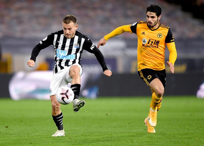 Newcastle United's Ryan Fraser,  left, and Wolverhampton Wanderers' Pedro Neto battle for the ball. PA