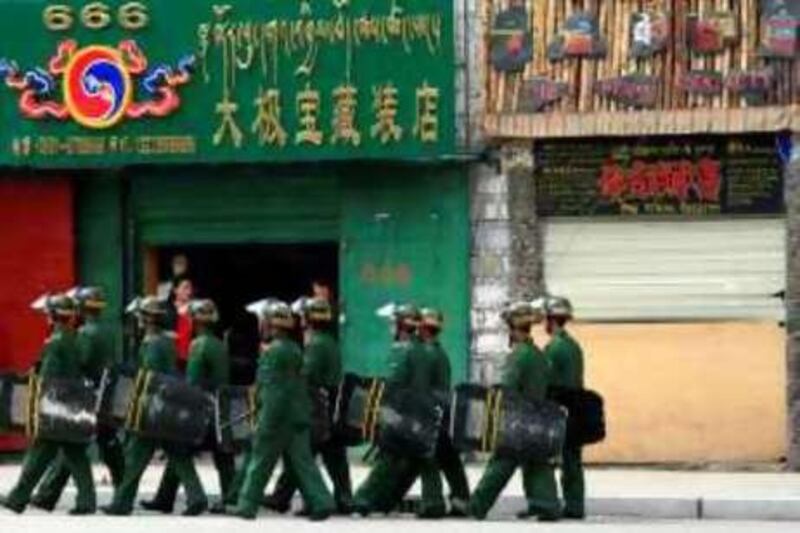 Paramilitary policemen patrol along a street in Lhasa, Tibet Autonomous Region, May 9, 2008. The mid-March Lhasa violence and its aftermath reduced Tibet's economic growth by 6.6 percentage points in the first quarter said Qiangba Puncog, chairman of Tibet's regional government, according to Xinhua News Agency. Picture taken May 9, 2008. REUTERS/Stringer (CHINA).  CHINA OUT. NO COMMERCIAL OR EDITORIAL SALES IN CHINA.