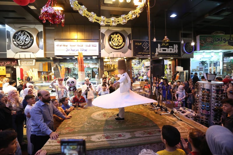 Shoppers in Al Midan souq in Damascus, Syria on the eve of Eid Al Fitr. EPA