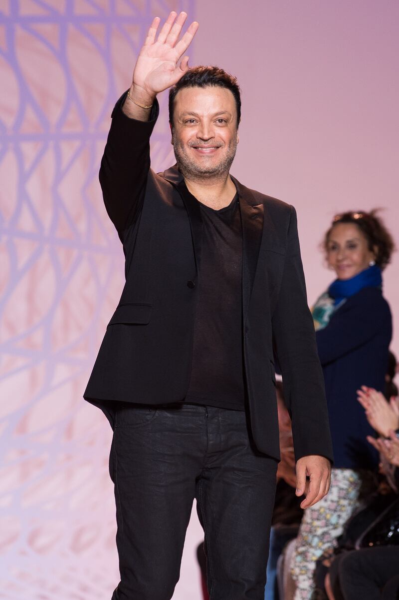 Zuhair Murad waves to the crowd during Paris Fashion Week on July 10, 2014. Getty