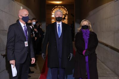 Former U.S. President Bill Clinton, center, and Hillary Clinton, former U.S. secretary of state, arrive to the 59th presidential inauguration in Washington, D.C., U.S., on Wednesday, Jan. 20, 2021. Biden will propose a broad immigration overhaul on his first day as president, including a shortened pathway to U.S. citizenship for undocumented migrants - a complete reversal from Donald Trump's immigration restrictions and crackdowns, but one that faces major roadblocks in Congress. Photographer: Win McNamee/Getty Images/Bloomberg