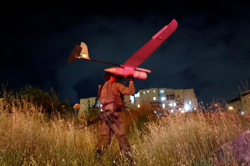 Israeli forces fly a drone to help locate the suspects. AFP