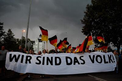 TOPSHOT - CORRECTION - People hold a giant banner reading "we are the people" during a march organised by the right-wing populist "Pro Chemnitz" movement, on September 7, 2018 in Chemnitz, the flashpoint eastern city that saw protests marred by neo-Nazi violence. - The rally is to be followed by a concert which counterprotesters called "Stronger Together" urging "openness and diversity". (Photo by John MACDOUGALL / AFP) / “The erroneous mention[s] appearing in the metadata of this photo by John MACDOUGALL has been modified in AFP systems in the following manner: [a march organised by the Pro Chemnitz movement] instead of [organised by Pro Chemnitz movement, Pedida and AfD]. Please immediately remove the erroneous mention[s] from all your online services and delete it (them) from your servers. If you have been authorized by AFP to distribute it (them) to third parties, please ensure that the same actions are carried out by them. Failure to promptly comply with these instructions will entail liability on your part for any continued or post notification usage. Therefore we thank you very much for all your attention and prompt action. We are sorry for the inconvenience this notification may cause and remain at your disposal for any further information you may require.”