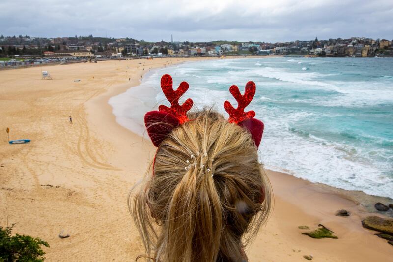 A woman wearing antlers looks at Bondi Beach in Sydney, Australia. Getty Images