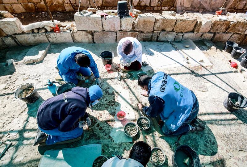 Workers on a project run by UN cultural agency Unesco restore a mosaic floor at an ancient church complex in the small town of Rihab, 70 kilometres north of Jordan's capital Amman. AFP
