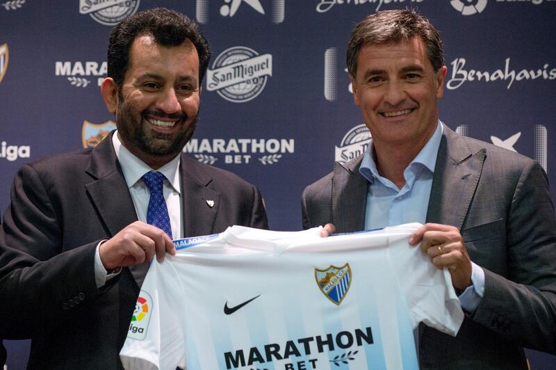 Malaga's new coach Jose Miguel Gonzalez Martin del Campo aka Michel (R) poses with Malaga CF's chairman Sheikh Abdallah Ben Nasser Al-Thani during his official presentation at the Rosaleda stadium in Malaga, on March 8, 2017. (Photo by JORGE GUERRERO / AFP)