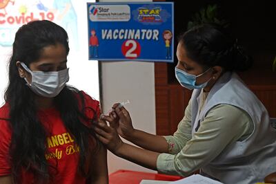 A girl is inoculated with a dose of the Covaxin vaccine, in New Delhi. AFP