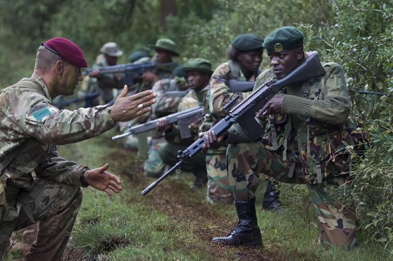 Rangers of the Kenya Wildlife Service and Kenya Forest Service receive instructions from British Army paratrooper, Cpl Andrew Smith, during an anti-poaching training demonstration near Nanyuki, 200km north of Nairobi, Kenya. Dai Kurokawa / EPA