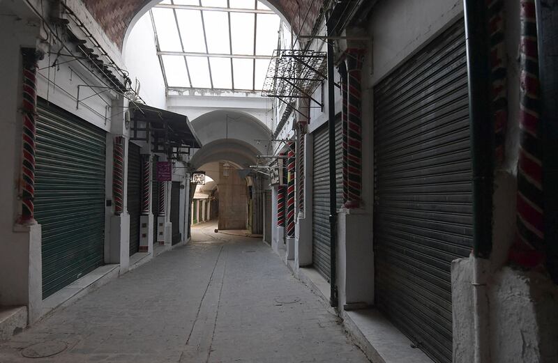 This picture taken on May 24, 2020 on the first day of Eid al-Fitr, the Muslim holiday which starts at the conclusion of the holy fasting month of Ramadan, shows a view of a deserted alley near the Zitouna mosque in the Medina (old town) of the Tunisian capital Tunis, at which shops have been closed for over two months due to the COVID-19 coronavirus pandemic. - Tunisia will reopen places of worship, restaurants and hotels from June 4, more than two months after closing them over the coronavirus pandemic. Travel between provinces remains forbidden and security checks will be increased during Eid al-Fitr, when people traditionally visit family. (Photo by FETHI BELAID / AFP)