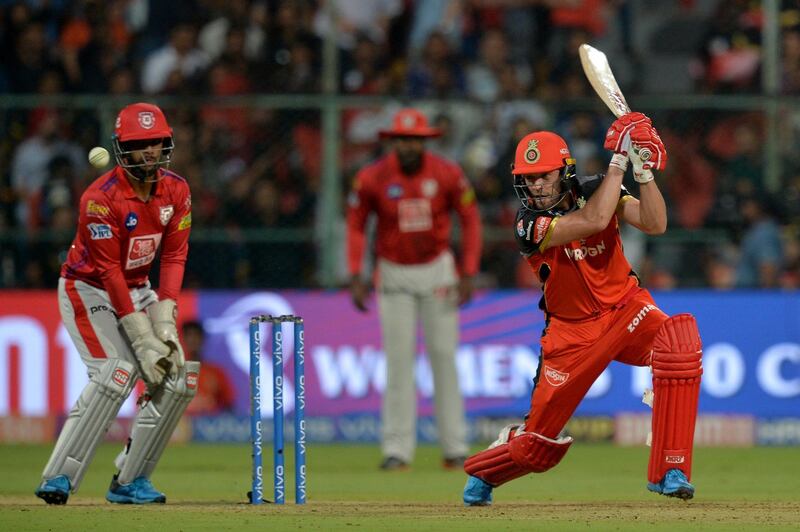 Royal Challengers Bangalore batsman AB De Villiers (R) plays a shot while Kings XI Punjab wicketkeeper Nicholas Pooran (L) looks on during the 2019 Indian Premier League (IPL) Twenty20 cricket match between Royal Challengers Bangalore and Kings XI Punjab at The M. Chinnaswamy Stadium in Bangalore on April 24, 2019. (Photo by Manjunath KIRAN / AFP) / ----IMAGE RESTRICTED TO EDITORIAL USE - STRICTLY NO COMMERCIAL USE-----
