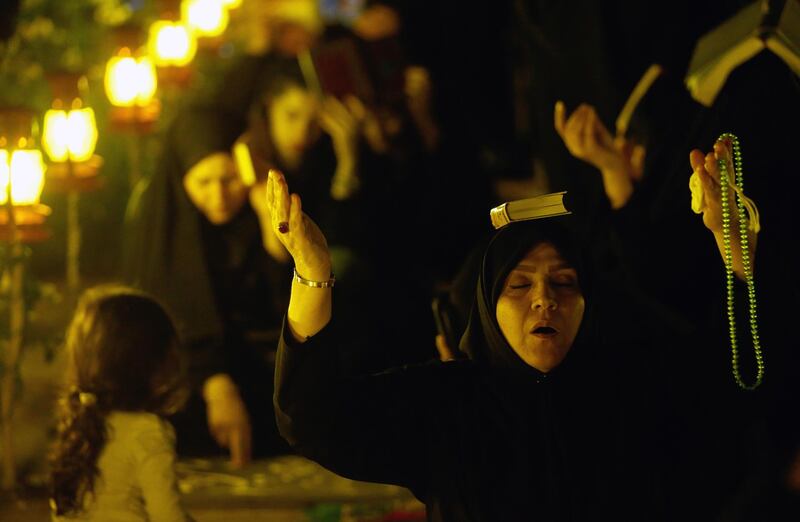 Iranian women pray around the graves at the Behesht-Zahra cemetery, in southern Tehran.  EPA