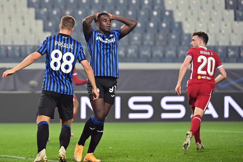 Atalanta's Colombian forward Duvan Zapata reacts next to Liverpool's Portuguese striker Diogo Jota. AFP